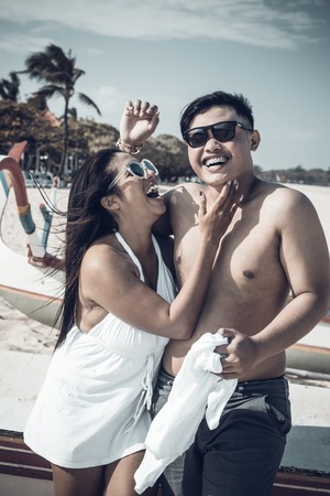 Asian couple having fun on the beach of tropical Bali island, Indonesia.の写真素材