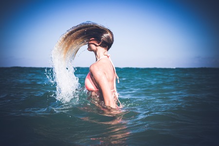 Beautiful young sexy womanhaving fun in refreshing sea water. Bali island.の写真素材