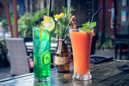 Healthy fruity papaya juice and lemonade in a glass on a wooden table. Bali island.の写真素材