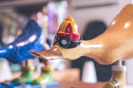 Hancrafted and hand painted funny wooden duck in souvenir shop on a tropical island of Bali, Indonesia.の写真素材