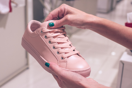 Young woman wearing new shoes in a shopping mall of Bali island, Indonesia.の写真素材