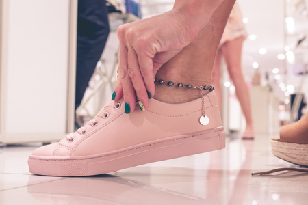 Young woman wearing new shoes in a shopping mall of Bali island, Indonesia.の写真素材