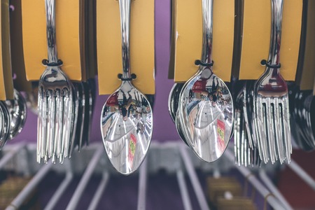 Stainless spoons and fork set hanging in the store. Shopping mall, Bali island.の写真素材