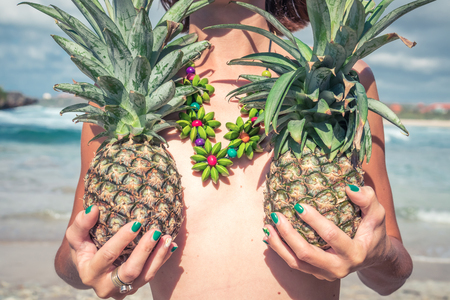 Tropical summer woman with pineapple. Outdoors, ocean, nature. Bali island paradise.の写真素材