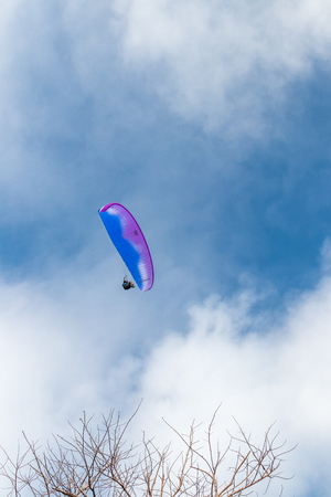 Raraplane flying in the beautiful sky. Tropical Bali island, Indonesia. Extreme sport.の写真素材