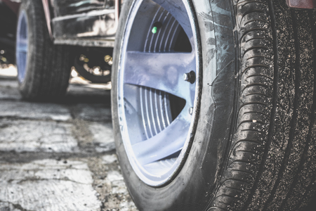 Close up of dirty car wheel on the road. Bali island.の写真素材