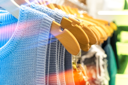 Close up of women clothes hanging in the store. Shopping mall. Fashion concept.の写真素材