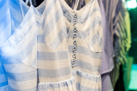 Close up of women clothes hanging in the store. Shopping mall. Fashion concept.の写真素材