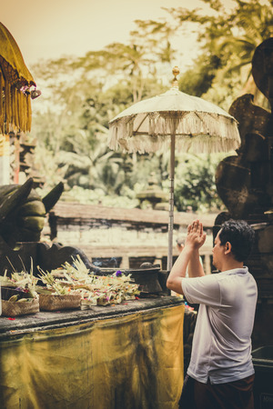 BALI, INDONESIA - DECEMBER 5, 2017: Balinese man praying in Tirta Empul Temple.のeditorial素材