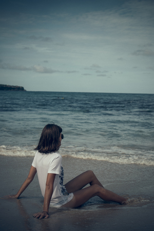 Beautiful young woman posing on the beach of a tropical island of Bali, Indonesia.の写真素材