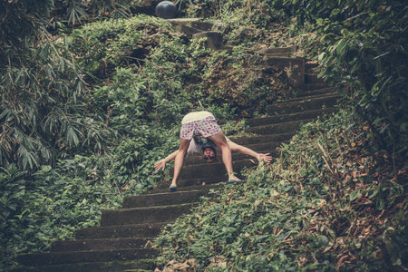 BALI, INDONESIA - JANUARY 10, 2018: Man Touristshaving fun on stairs, road from the beach. Tropical...