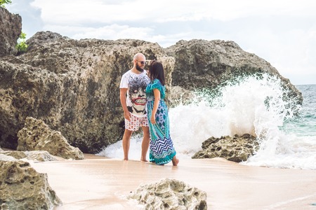BALI, INDONESIA - JANUARY 10, 2018: Happy young honeymoon couple posing on the beach. Ocean, tropical vacation on Bali island, Indonesia.のeditorial素材