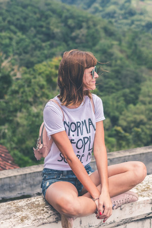 Beautiful young woman in sunglasses on tropical jungle background. Bali island, Indonesia. Asia.
