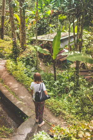 Woman in the deep rainforest. Tropical jungle, Bali island, Indonesia.の写真素材