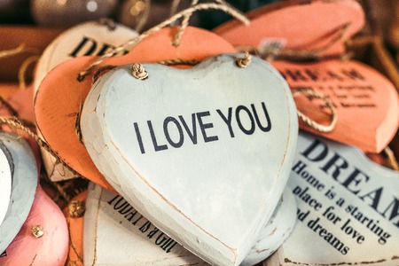 Wooden hearts with romantic text. Souvenir shop on Bali island.の写真素材