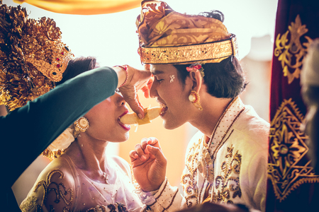 BALI, INDONESIA - APRIL 13, 2018: Newlyweds on balinese wedding ceremony. Traditional wedding.のeditorial素材