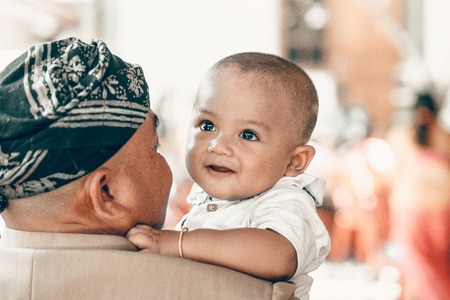 BALI, INDONESIA - APRIL 13, 2018: Asian kid on balinese wedding day. Indonesian child.のeditorial素材