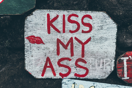 Kiss my ass wooden plate in the jungle of Bali island.の写真素材