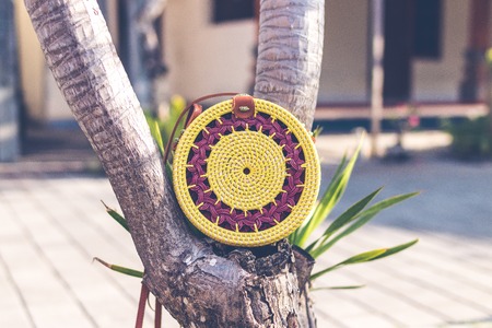 Natural organic handmade rattan handbag closeup. Yellow color.の写真素材