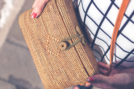 Fashionable stylish rattan bag outside. Tropical island of Bali, Indonesia. Rattan handbag.の写真素材