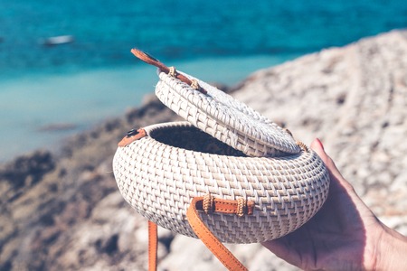 Fashionable stylish rattan bag outside. Tropical island of Bali, Indonesia. Rattan handbag.の写真素材