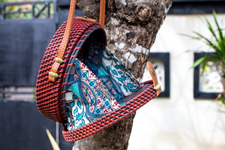 Fashionable stylish rattan bag outside. Tropical island of Bali, Indonesia. Rattan handbag.の写真素材