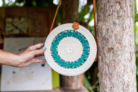 Fashionable stylish rattan bag in the tropical garden.の写真素材