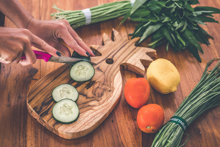 Teak Cutting Board, vegetables on wooden table. Tomato, cucumber. Cooking with vegetables.の写真素材