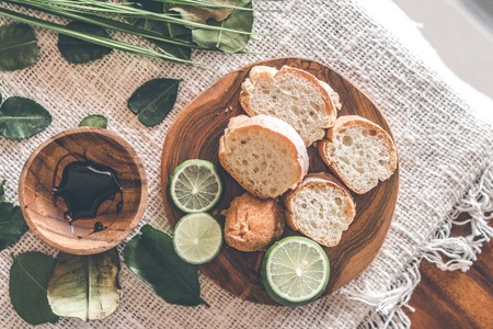 Sliced bread on wooden table with fresh and green lime.の写真素材