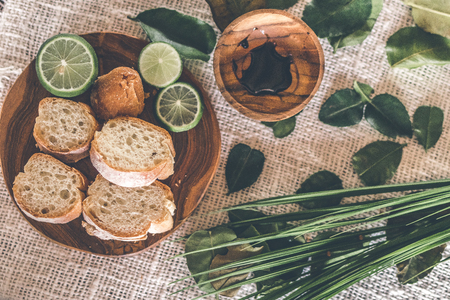 Sliced bread on wooden table with fresh and green lime.の写真素材