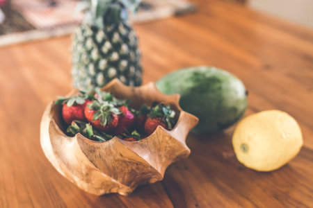 Strawberries in a wooden teak bowl. Indonesian teak bowl.の写真素材