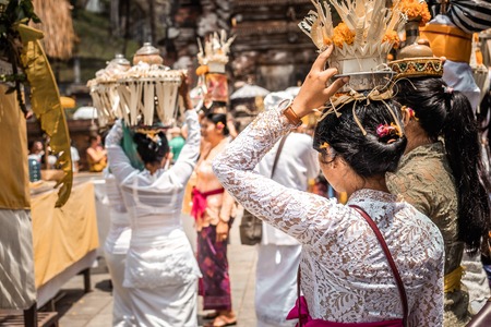 BALI, INDONESIA - SEPTEMBER 25, 2018: Balinese women in traditional clothes on a big ceremony in famous Tirta Empul Temple.のeditorial素材