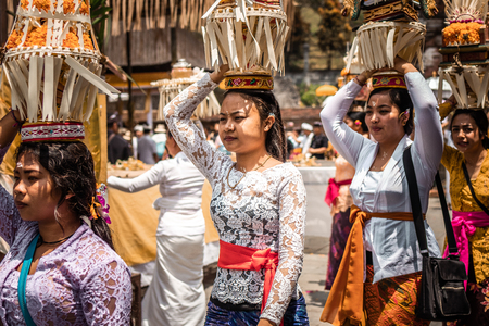 BALI, INDONESIA - SEPTEMBER 25, 2018: Balinese women in traditional clothes on a big ceremony in famous Tirta Empul Temple.のeditorial素材
