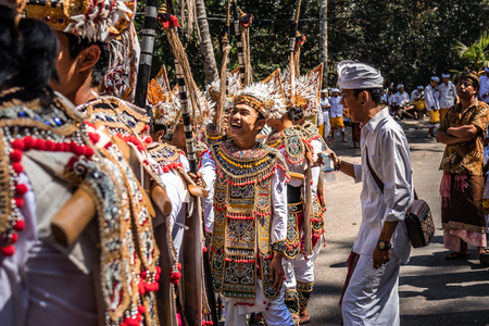 BALI, INDONESIA - SEPTEMBER 25, 2018: Balinese men in traditional clothes on a big ceremony in Tirta Empul Temple.のeditorial素材