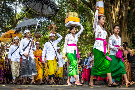BALI, INDONESIA - SEPTEMBER 25, 2018: Balinese women in traditional clothes on a big ceremony in famous Tirta Empul Temple.のeditorial素材