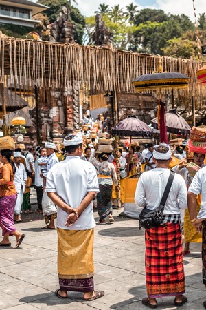 BALI, INDONESIA - SEPTEMBER 25, 2018: Balinese men in traditional clothes on a big ceremony in Tirta Empul Temple.のeditorial素材