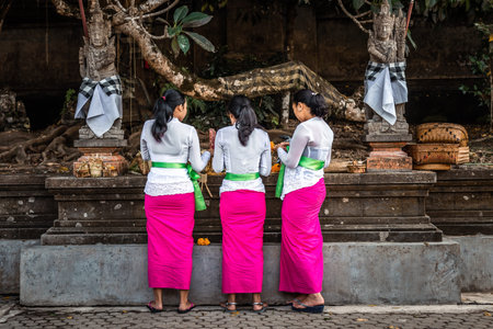 BALI, INDONESIA - SEPTEMBER 25, 2018: Balinese women in traditional clothes on a big ceremony in famous Tirta Empul Temple.のeditorial素材
