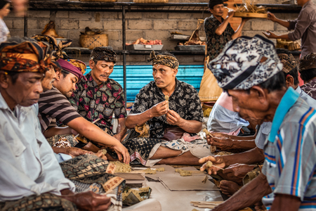 BALI, INDONESIA - SEPTEMBER 25, 2018: Men preparing for cooking traditional balinese food in a famous Tirta Empul Temple.のeditorial素材