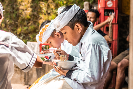 BALI, INDONESIA - SEPTEMBER 25, 2018: Balinese children in traditional clothes on a big ceremony in Tirta Empul Temple.のeditorial素材