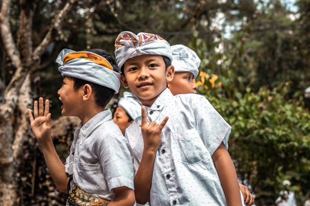 BALI, INDONESIA - SEPTEMBER 25, 2018: Balinese children in traditional clothes on a big ceremony in Tirta Empul Temple.のeditorial素材