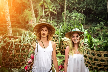 Young honeymoon couple on rice fields of Bali island. Travel vacation on Bali concept.の写真素材