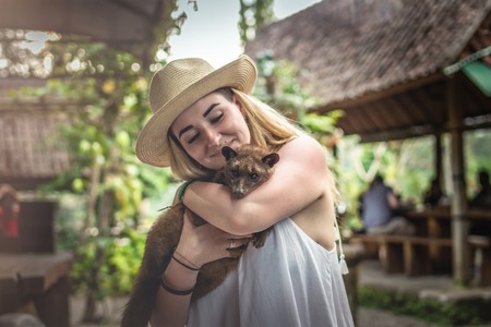Young woman with musang coffee kopi luwak producer. Bali island.の写真素材