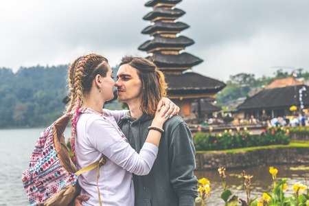 Young romantic couple of trourists on the Ulan Danu temple background. Bali island.の写真素材