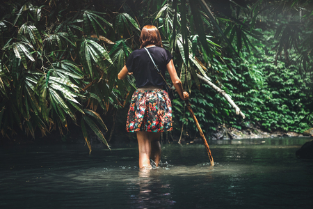 Young woman tourist with straw hat in the rainforest of Bali island. Indonesia.の写真素材
