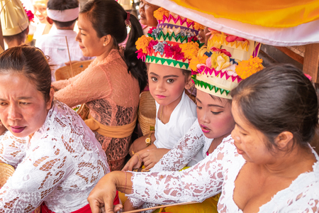 BALI, INDONESIA - OCTOBER 3, 2018: Balinese girls in traditional costume on a balinese family ceremony in desa Pejeng Kangi.のeditorial素材