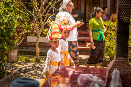 BALI, INDONESIA - OCTOBER 3, 2018: Balinese girls in traditional costume on a balinese family ceremony in desa Pejeng Kangi.のeditorial素材