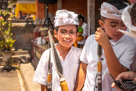 BALI, INDONESIA - OCTOBER 3, 2018: Balinese kids in traditional costume on a balinese family ceremony in desa Pejeng Kangi.のeditorial素材