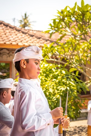 BALI, INDONESIA - OCTOBER 3, 2018: Balinese boy in traditional costume on a balinese family ceremony in desa Pejeng Kangi.のeditorial素材
