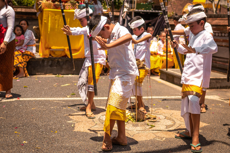 BALI, INDONESIA - OCTOBER 3, 2018: Balinese boys ritual dance in traditional costume on a balinese family ceremony in desa Pejeng Kangi.のeditorial素材
