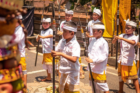 BALI, INDONESIA - OCTOBER 3, 2018: Balinese boys ritual dance in traditional costume on a balinese family ceremony in desa Pejeng Kangi.のeditorial素材